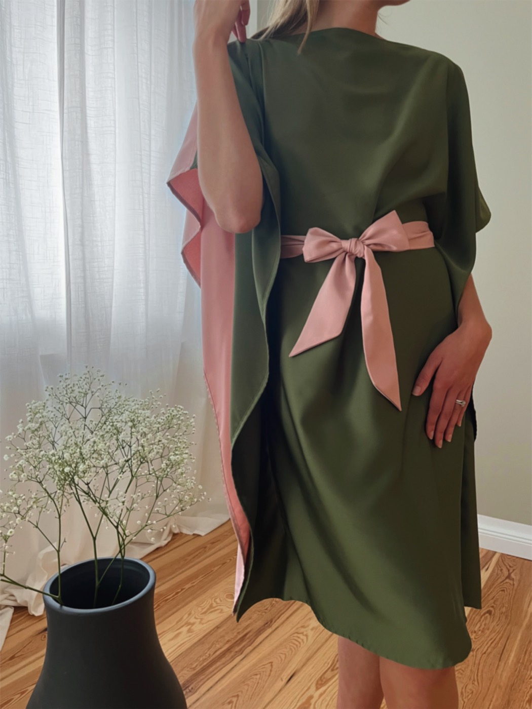 Green and rose dress with a rose sash, from behind